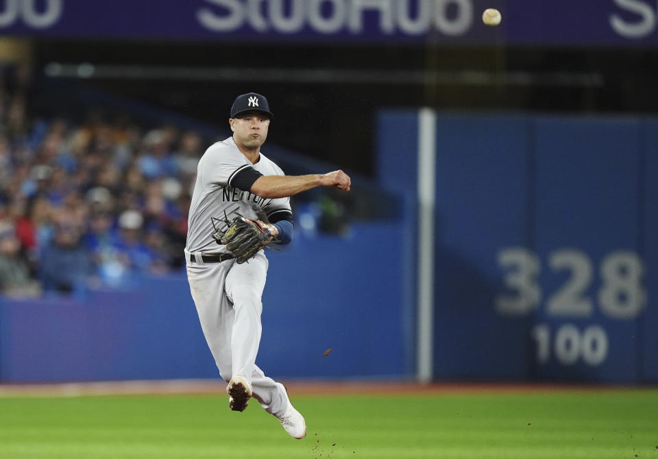 New York Yankees shortstop Isiah Kiner-Falefa throws to first for the out on Toronto Blue Jays' Raimel Tapia during the second inning of a baseball game Tuesday, Sept. 27, 2022, in Toronto. (Nathan Denette/The Canadian Press via AP)