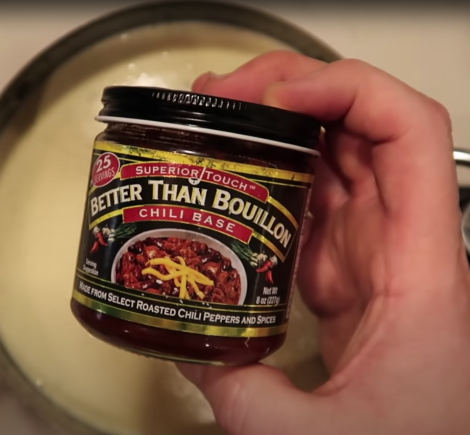 a hand holding Better Than Bouillon Chili Base