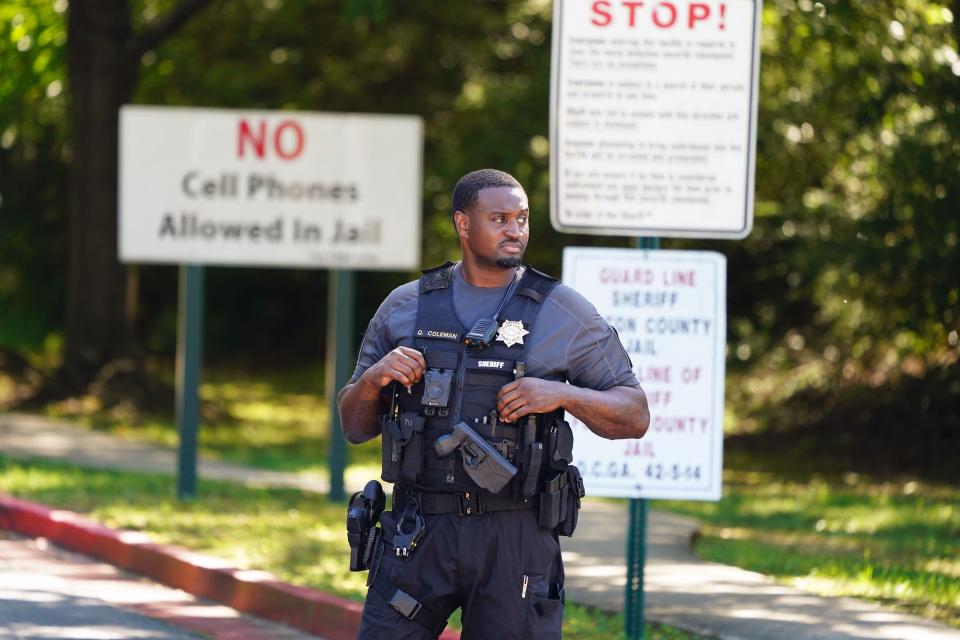 Fulton County Sheriff deputies secure the entrance outside the Fulton County Jail in Atlanta on Aug. 16, 2023 following a grand jury in Fulton County, Ga. that indicted Donald Trump. The indictment includes 41 charges against 19 defendants, from the former president to his former attorney Rudy Guiliani and former White House Chief of Staff Mark Meadows. The legal case centers on the state’s RICO statute, the Racketeer Influenced and Corrupt Organizations Act.