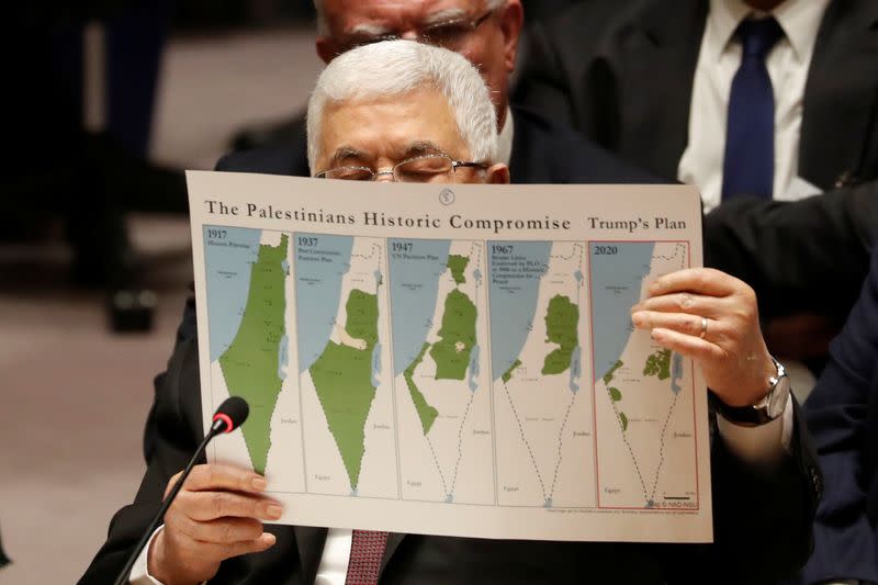Palestinian President Mahmoud Abbas holds a document while speaking during a Security Council meeting at the United Nations in New York