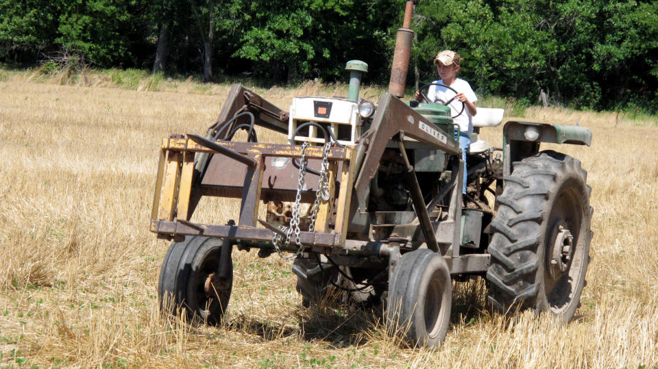 In a June 20, 2012, photo ten-year-old Jacob Mosbacher guides a tractor through a bean field on his grandparents' property near Fults, Ill. Agriculture organizations and federal lawmakers from farm states succeeded last spring in convincing the U.S. Labor Department to drop proposals limiting farm work by children such as Jacob, whose parents say such questions of safety involving kids should be left to parents. (AP Photo/Jim Suhr)