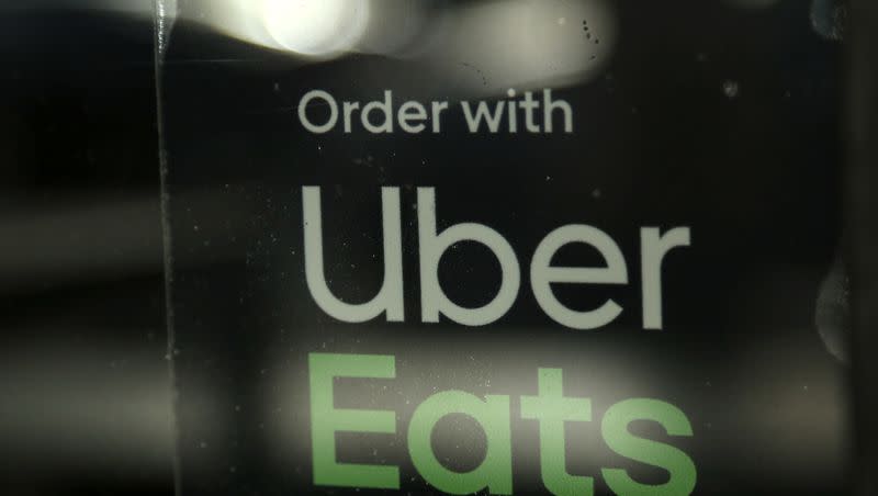 In this Nov. 6, 2019, file photo, a restaurant advertises Uber Eats in Miami. A Florida man was charged with the murder and dismemberment of an Uber Eats driver, reports say.