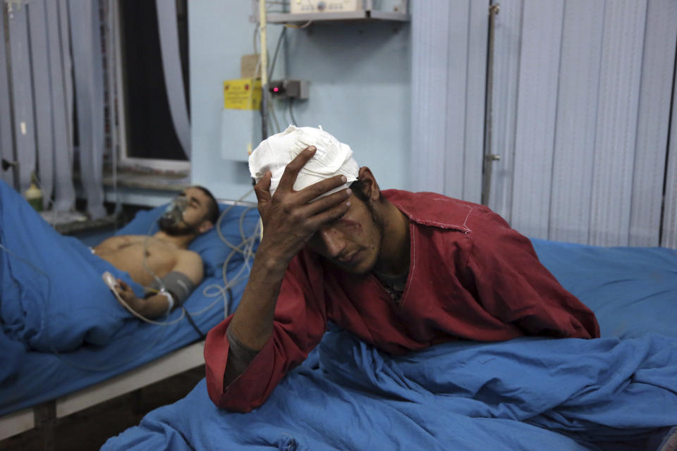 Injured men receive treatment at a hospital after a suicide bombing in Kabul, Afghanistan, Nov. 20, 2018. Afghan officials said the suicide bomber targeted a gathering of Muslim religious scholars in Kabul. (AP Photo/Rahmat Gul)