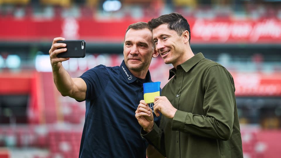 Lewandowski receives a Ukraine armband from Laureus Ambassador Andriy Shevchenko and pledges to carry it to the 2022 World Cup in Qatar at PGE Narodowy Stadium on September 20, 2022 in Warsaw, Poland. - Joosep Martinson/Getty Images