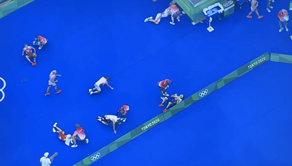 The scene at the finish line of the men's triathlon looked like a battlefield, with athletes seemingly overcome by the intense heat in Tokyo.