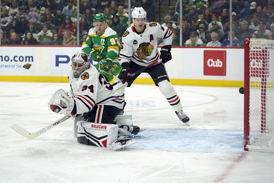 Chicago Blackhawks goaltender Petr Mrazek (34) gives up a goal to Minnesota Wild center Marco Rossi (not pictured) during the first period of an NHL hockey game Sunday, Dec. 3, 2023, in St. Paul, Minn. (AP Photo/Abbie Parr)