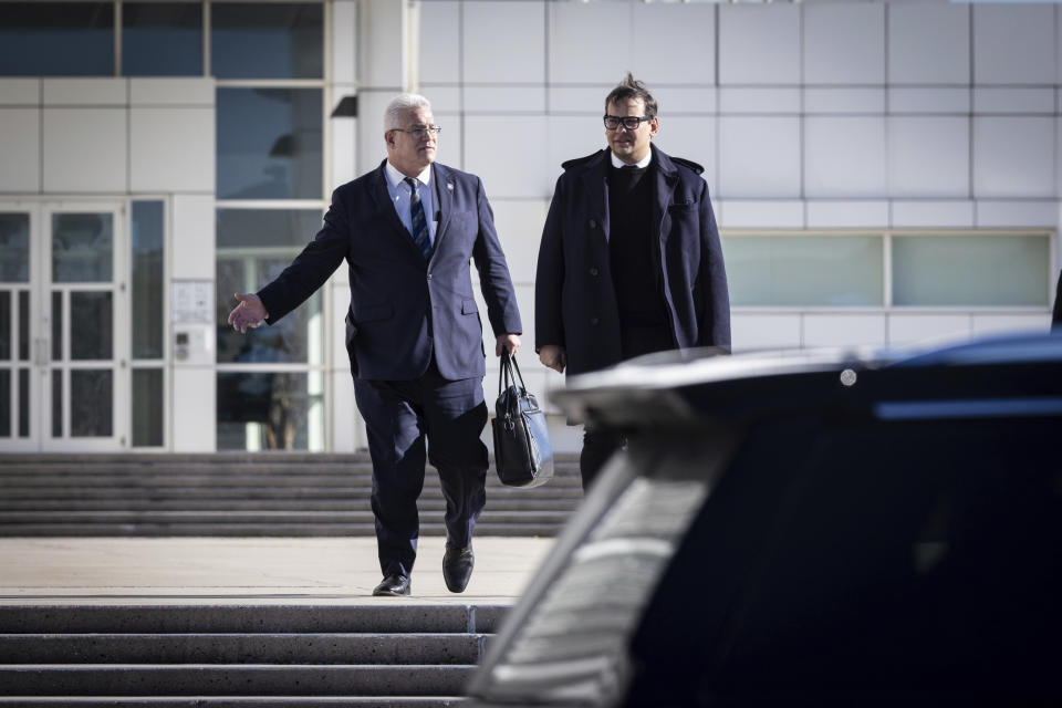 Former U.S. Rep George Santos leaves the federal courthouse with his lawyer in Central Islip, N.Y. on, Tuesday, Dec. 12, 2023, in New York. (AP Photo/Stefan Jeremiah)