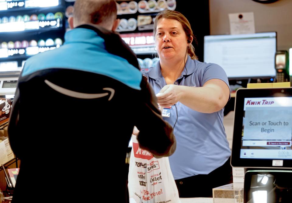 Lindsey Zettel, assistant store leader, checks out a customers at the Kwik Trip at 2807 River Valley Road in Waukesha.