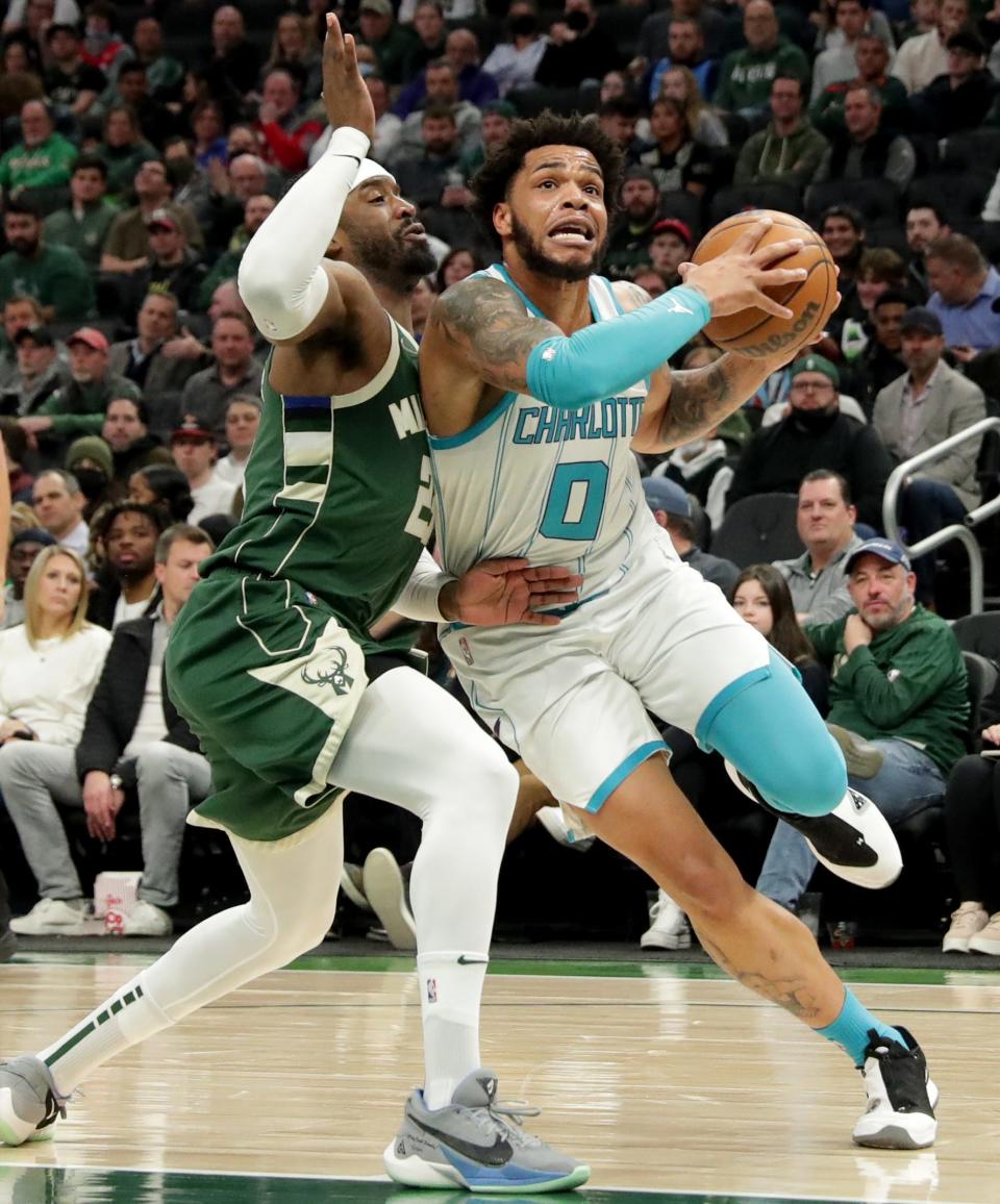 Charlotte Hornets forward Miles Bridges (0) drives past Milwaukee Bucks guard Wesley Matthews (23) during the first half of their game Monday, February 28, 2022 at Fiserv Forum in Milwaukee, Wis.