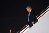 U.S. President Donald Trump descends from Air Force One at Joint Base Andrews