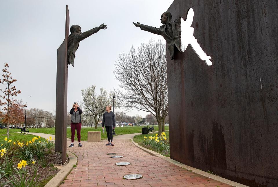 Patricia Bates takes a photo as she and daughter, Shelby Bates, pass through the Landmark for Peace Memorial in Dr. Martin Luther King Jr. Park in Indianapolis on Saturday, April 4, 2020. The day marks 52 years since the assassination of Martin Luther King Jr. and the night Robert F. Kennedy addressed a crowd of Indianapolis residents in the area now known as the Kennedy-King neighborhood. Kennedy delivered the impromptu speech from the back of a flatbed truck, encouraging peace and forgiveness amid national violence. Since the annual commemoration could not be held in person due to COVID-19 precautions, a video tribute was posted online at WISH-TV.