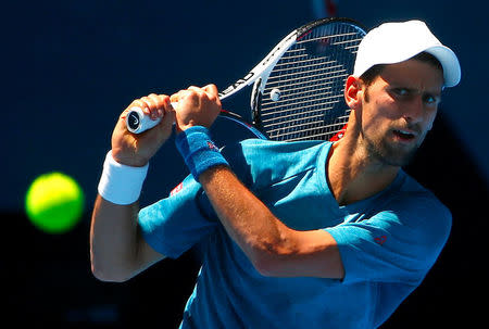 Serbia's Novak Djokovic hits a shot during a training session ahead of the Australian Open tennis tournament in Melbourne, Australia, January 12, 2017. REUTERS/David Gray