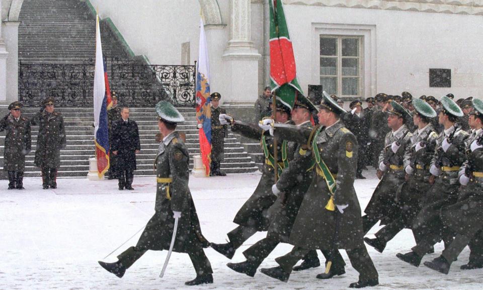 Soldiers march in front of Russian President Vladimir Putin during a ceremony at the Kremlin in Moscow, Feb. 21, 2002, devoted to the Day of Defenders of Fatherland.