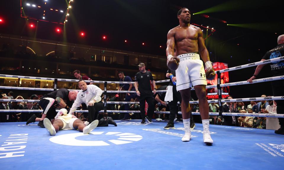 <span>Anthony Joshua returns calmly to his corner after knocking out Francis N'Gannou in Riyadh, Saudi Arabia. </span><span>Photograph: Mark Robinson/Matchroom Boxing/Getty Images</span>