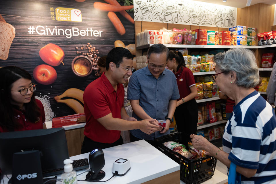 Minister for Social and Family Development Desmond Lee (red shirt) and Mountbatten SMC MP Lim Biow Chuan (blue shirt) at the opening of the Community Shop@Mountbatten. (PHOTO: OCBC)