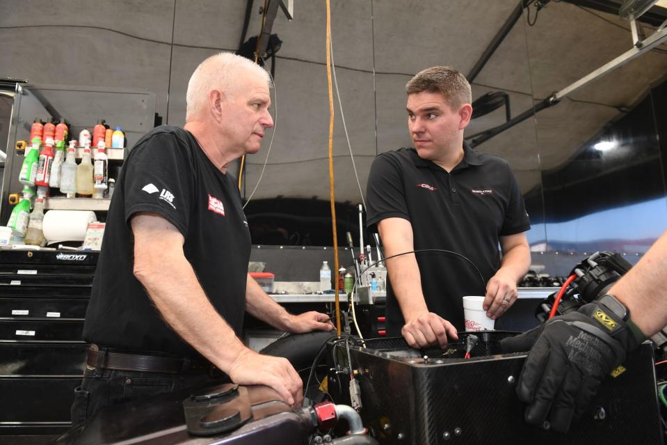 Springfield's Daniel Wilkerson (right) consults with his father, NHRA Funny Car racer Tim Wilkerson. Daniel Wilkerson is a crew chief for Chad Green, of Midland, Texas.