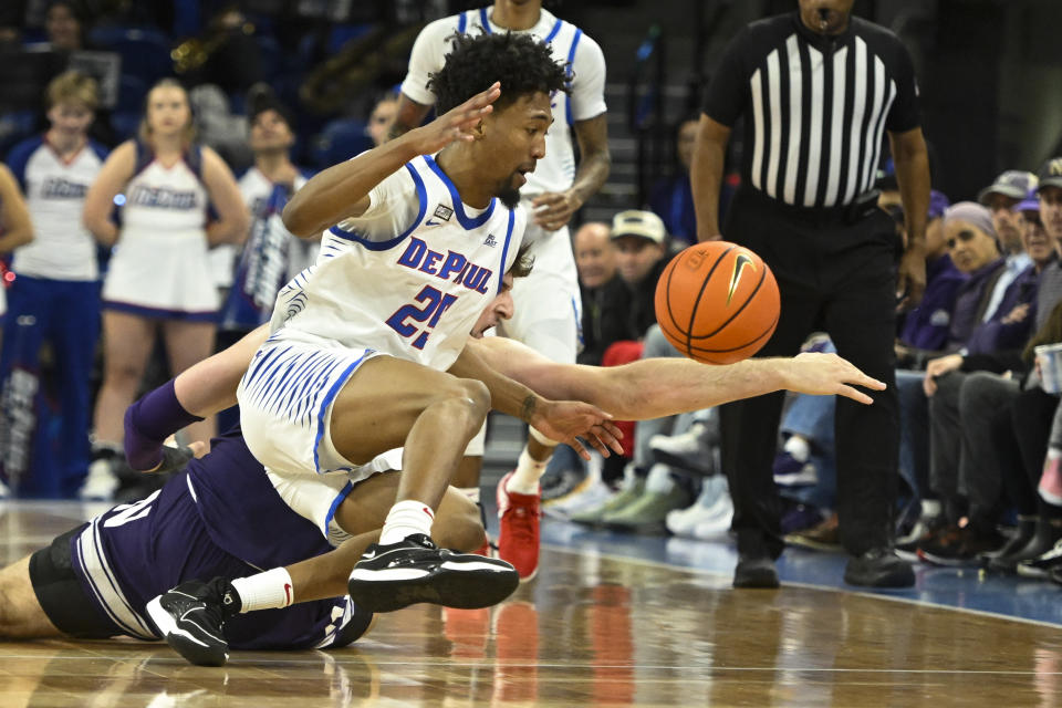 DePaul forward Jeremiah Oden (25) and Northwestern center Matthew Nicholson, back, chase the ball during the first half of an NCAA college basketball game, Saturday, Dec. 16, 2023, in Chicago. (AP Photo/Matt Marton)