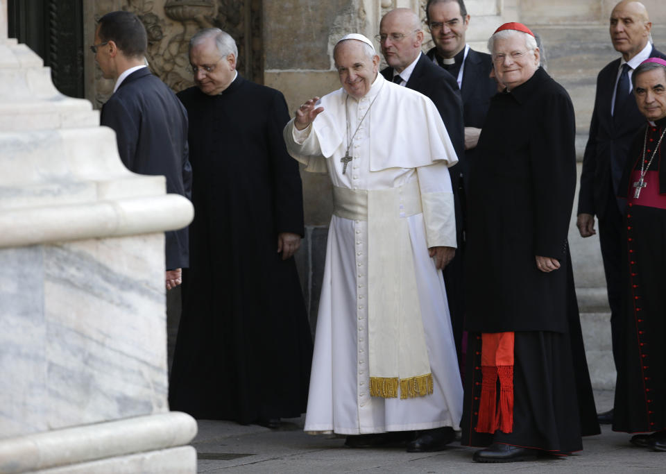 Pope Francis, flanked by Cardinal Angelo Scola, right, waves as he arrives at Milan’s Duomo Cathedral to meet members of the Catholic Church, as part of his one-day pastoral visit to Monza and Milan, Italy’s second-largest city, Saturday, March 25, 2017. The pontiff will offer a blessing at the Gothic-era Duomo cathedral. (AP Photo/Luca Bruno)