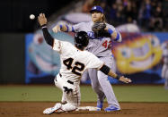 Los Angeles Dodgers second baseman Justin Turner, top, turns a double play over San Francisco Giants' Gregor Blanco after a ground ball by Brandon Hicks during the eighth inning of a baseball game on Tuesday, April 15, 2014, in San Francisco. (AP Photo/Marcio Jose Sanchez)