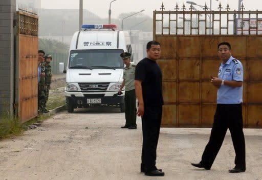 Chinese police wait outside the Number Two prison after the release of dissident Wang Xiaoning in Beijing