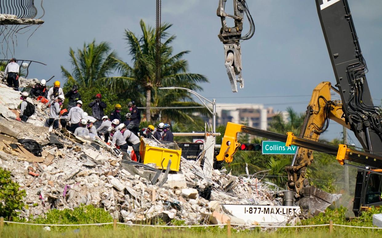 Workers search the rubble at the Champlain Towers South Condo - Lynne Sladky/AP