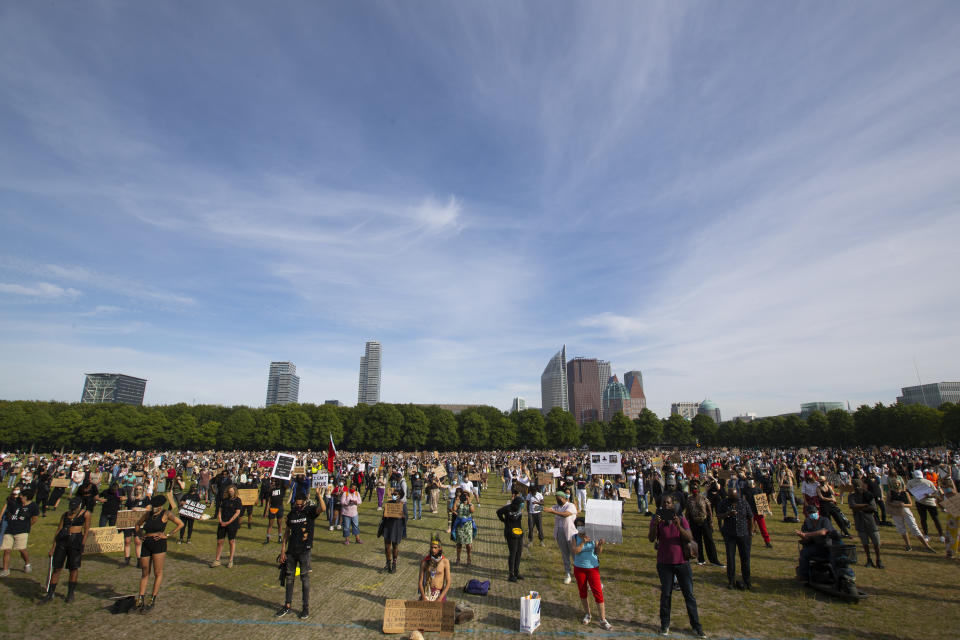 People observe social distancing as they take part in a demonstration in The Hague, Netherlands, Tuesday, June 2, 2020, to protest against the recent killing of George Floyd, police violence and institutionalized racism. Floyd, a black man, died in police custody in Minneapolis, U.S.A., after being restrained by police officers on Memorial Day. (AP Photo/Peter Dejong)