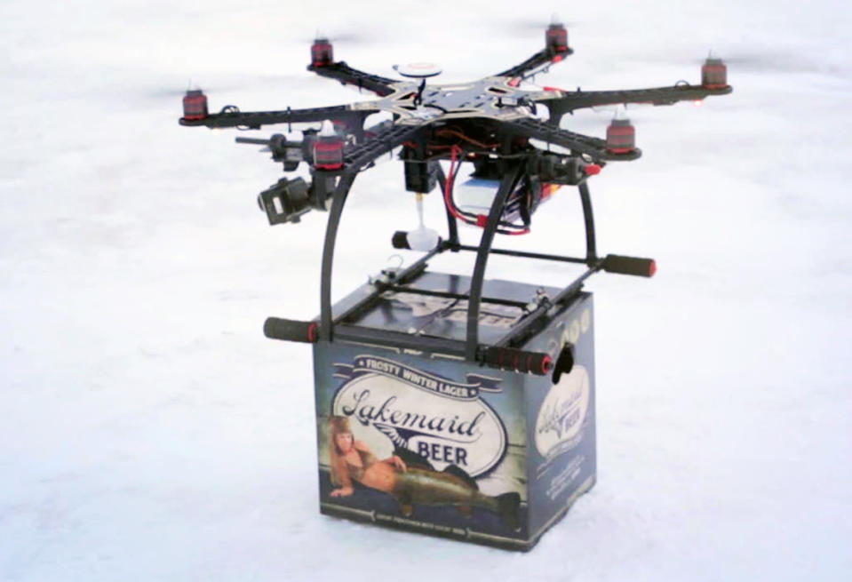 In this Jan. 16, 2014 image from video provided by Lakemaid Beer, a mini-drone lands with a 12-pack of beer for ice fishing anglers on Minnesota’s Lake Mille Lacs. Lakemaid president Jack Supple said he thought Amazon's package delivery plan would better be applied on a wide open frozen lake where ice anglers are manning their fishing holes in tiny shanties, but the Federal Aviation Administration heard him talking about his plans on the radio and grounded future deliveries. (AP Photo/Courtesy Lakemaid Beer)