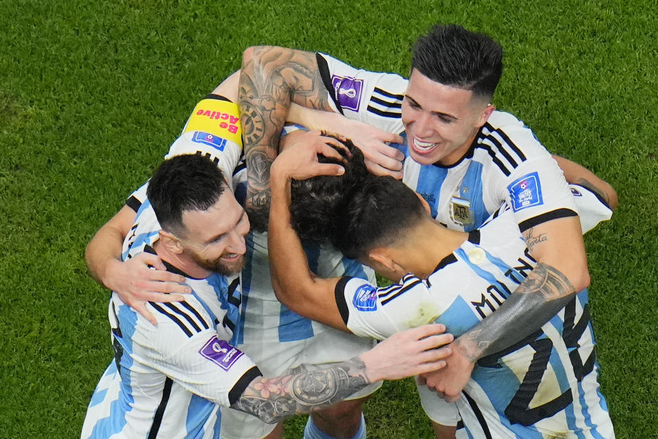 Argentina players celebrate with Argentina's Lionel Messi, left, who scored his side's first goal with a penalty shot during the World Cup semifinal soccer match between Argentina and Croatia at the Lusail Stadium in Lusail, Qatar, Tuesday, Dec. 13, 2022. (AP Photo/Hassan Ammar)