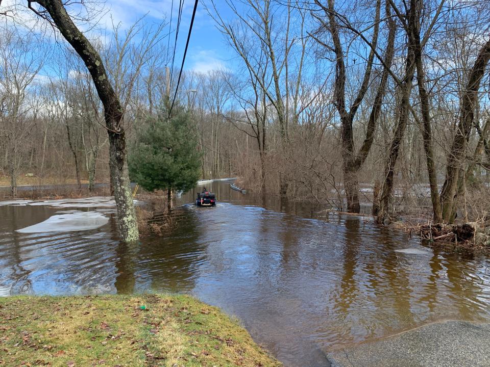 A resident of Belfield Drive in Johnston uses an ATV to reach his house, cut off from the rest of the street by flooding, after the heavy rain on Tuesday night and Wednesday.