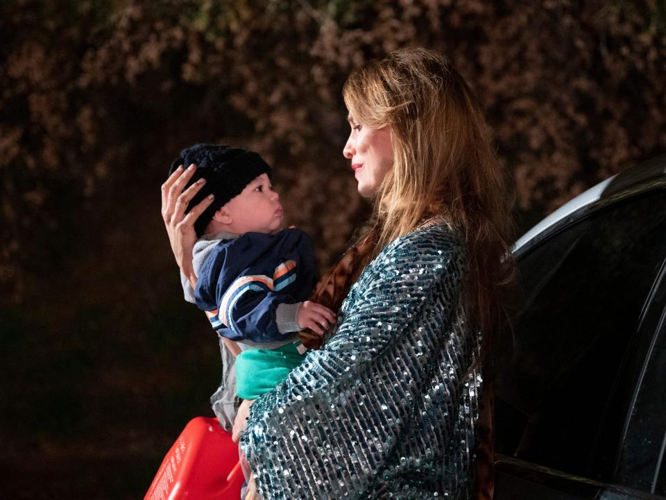 Dottie Quinn holding baby Henry on season 3 of "You"