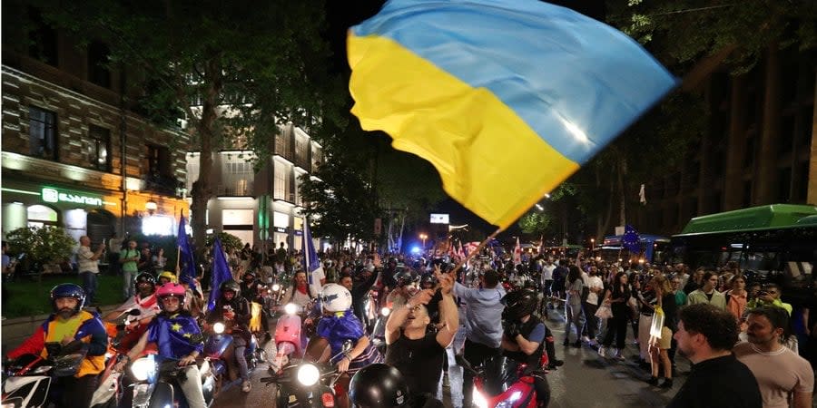A demonstrator waves a Ukrainian flag during a protest against the law on “foreign agents” in Tbilisi, Georgia, April 28, 2024.