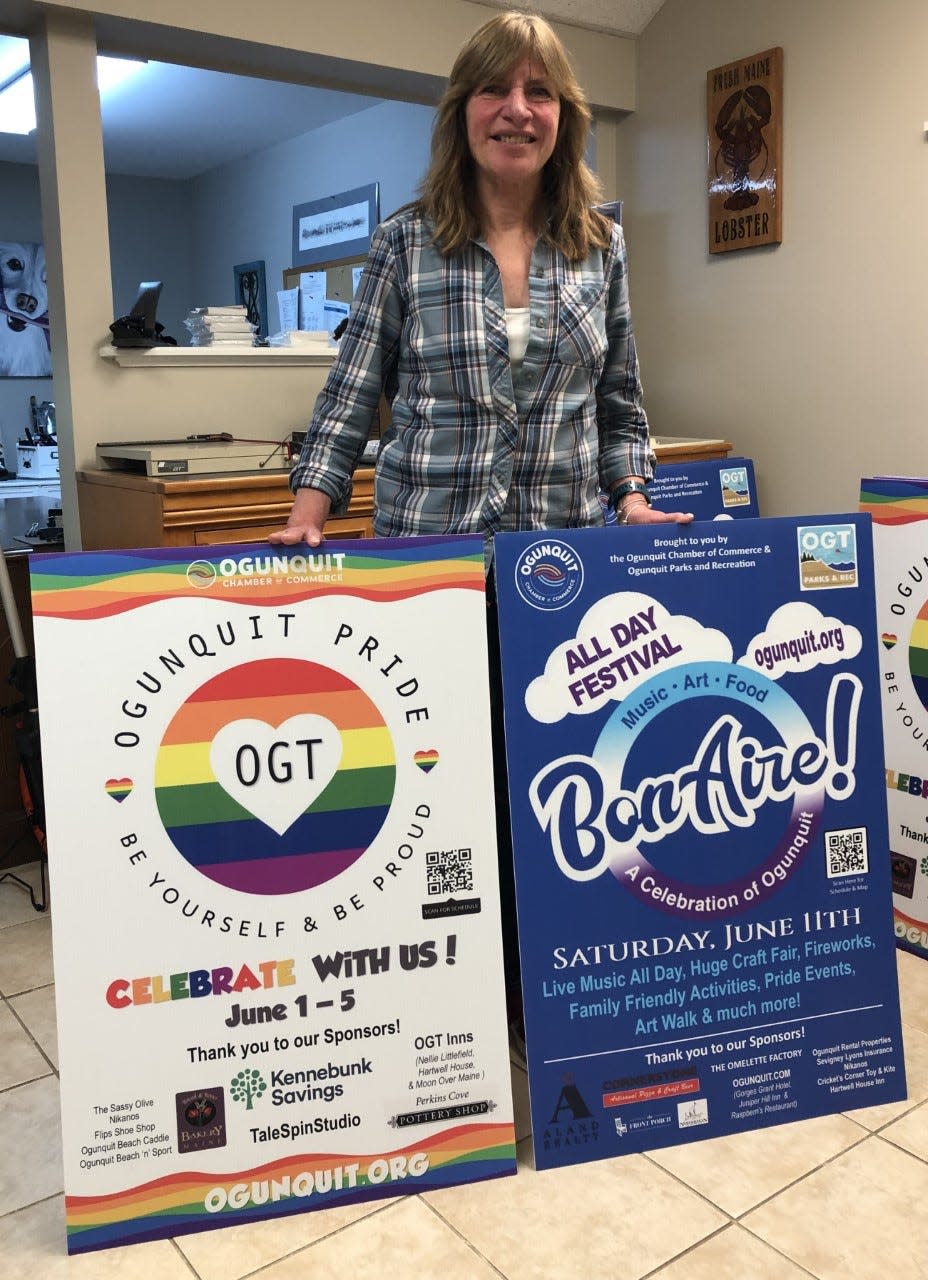 Alice Pearce, the executive director of the Ogunquit Chamber of Commerce, displays two banners that will be seen throughout the community as Ogunquit approaches its celebrations of Pride Month and its 40th anniversary as a town in June.