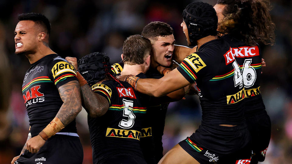 The Panthers celebrate around Nathan Cleary after his game-winning field goal against Newcastle.