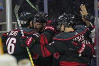 Carolina Hurricanes' Brady Skjei (76) and center Jordan Staal (11) celebrate Staal's goal against the Nashville Predators with defenseman Brett Pesce during the second period in Game 1 of an NHL hockey Stanley Cup first-round playoff series in Raleigh, N.C., Monday, May 17, 2021. (AP Photo/Gerry Broome)