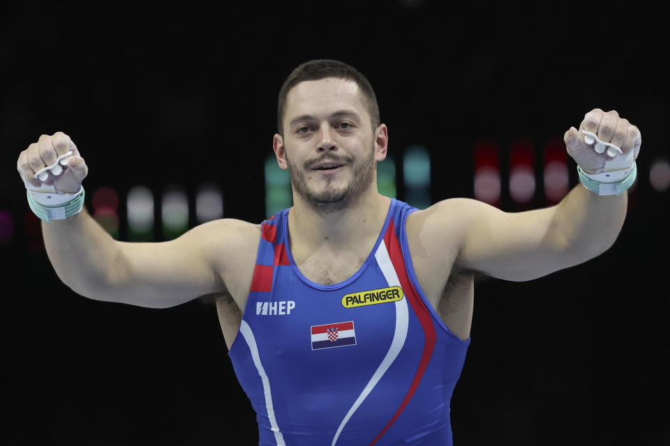 Croatia's Tin Srbic celebrates after his horizontal bar exercise during the apparatus finals at the Artistic Gymnastics World Championships in Antwerp, Belgium, Sunday, Oct. 8, 2023. (AP Photo/Geert vanden Wijngaert)