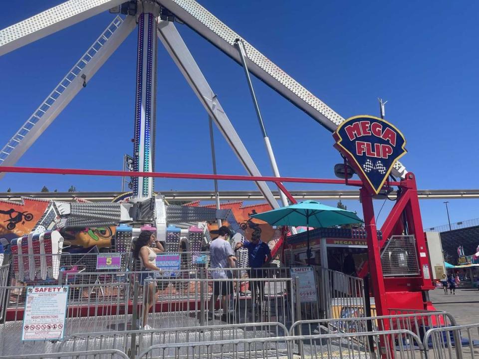 Mega Flip at the California State Fair has riders sit in a circle facing inwards, and swings them back and forth parallel to the ground.