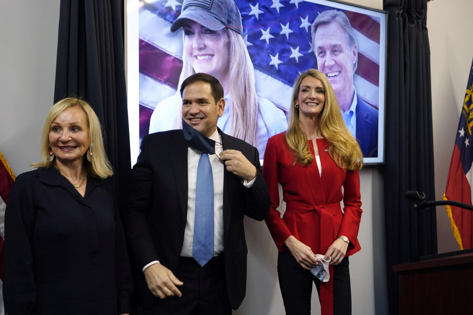 Sen. Marco Rubio, R-Fla., stands with Georgia Republican candidate for Senate Kelly Loeffler, right, and Bonnie Perdue, wife of Sen. David Perdue, R-Ga., after a campaign rally Wednesday, Nov. 11, 2020, in Marietta, Ga. (AP Photo/John Bazemore)