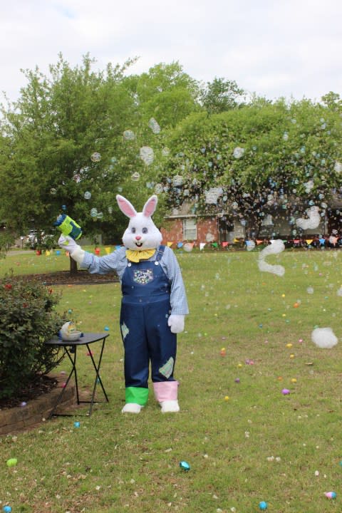 The Easter Bunny blowing bubbles at the Easter egg hunt. Photo Courtesy of StFrancisTyler.org.