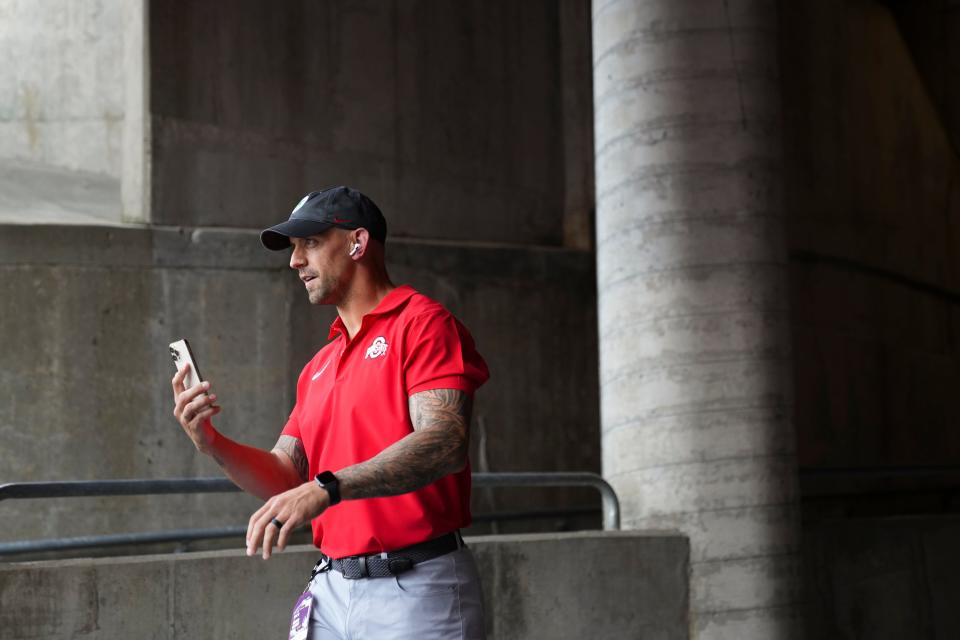 Sep 16, 2023; Columbus, Ohio, USA; Ohio State Buckeyes assitant coach James Laurinaitis talks on the phone as he heads to the field prior to the NCAA football game against the Western Kentucky Hilltoppers at Ohio Stadium.