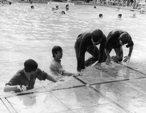 The Beatles climb out of the pool in Nassau (Getty)