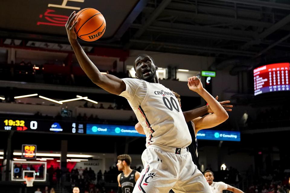 Cincinnati Bearcats forward Abdul Ado (00) pulls down a rebound in the first half of an NCAA menÕs college basketball game against the Monmouth Hawks, Saturday, Nov. 27, 2021, at Fifth Third Arena in Cincinnati. 