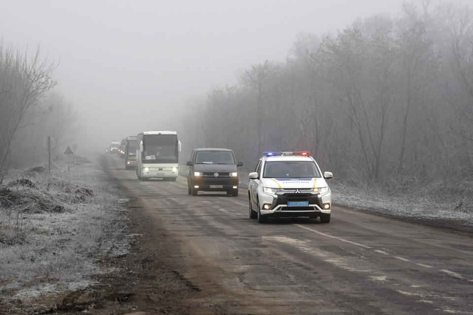 A column of buses with Russia-backed war prisoners drive to be exchanged near Odradivka, eastern Ukraine, Sunday, Dec. 29, 2019. Ukraine's president says his country expects to swap prisoners with Russia-backed separatists in the east on Sunday. (AP Photo/Evgeniy Maloletka)