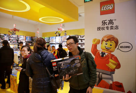 FILE PHOTO: A customer carries a Lego box at a Lego store in Beijing, China January 13, 2018. REUTERS/Jason Lee/File Photo