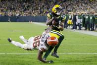 Green Bay Packers' Davante Adams catches a touchdown pass in front of Cleveland Browns' M.J. Stewart during the first half of an NFL football game Saturday, Dec. 25, 2021, in Green Bay, Wis. (AP Photo/Matt Ludtke)