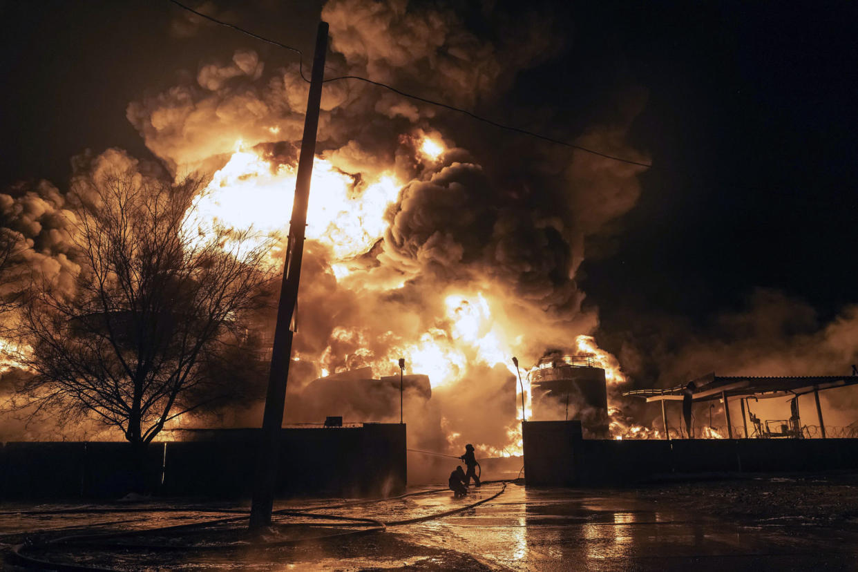 Firefighters extinguish a fire after a Russian attack on a residential neighborhood in Kharkiv, Ukraine, on Feb. 10. (Yevhen Titov / AP)