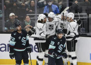 Los Angeles Kings center Adrian Kempe, second from right, celebrates his goal with teammates Alex Iafallo (19), Anze Kopitar, center and Matt Roy (3) as Seattle Kraken right wing Joonas Donskoi (72) and Seattle Kraken center Calle Jarnkrok (19) react during the first period of an NHL hockey game, Saturday, Jan. 15, 2022, in Seattle. (AP Photo/Lindsey Wasson)