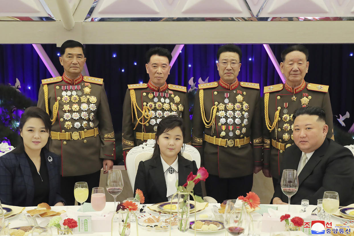 In this photo provided by the North Korean government, North Korean leader Kim Jong Un, right, with his wife Ri Sol Ju, left, and his daughter poses with military top officials for a photo at a feast to mark the 75th founding anniversary of the Korean People’s Army at an unspecified place in North Korea Tuesday, Feb. 7, 2023. Independent journalists were not given access to cover the event depicted in this image distributed by the North Korean government. The content of this image is as provided and cannot be independently verified. Korean language watermark on image as provided by source reads: "KCNA" which is the abbreviation for Korean Central News Agency. (Korean Central News Agency/Korea News Service via AP)