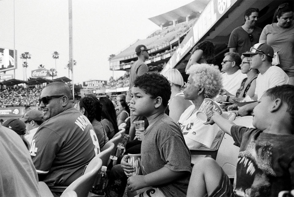 Matt Sayles sons and mother at a Dodgers game. I started my career as a sports photographer, says Sayles. I now spend hours watching my boys play baseball at fields all over L.A.