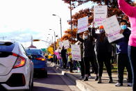 Canadian Union of Public Employees (CUPE) workers hold up signs along Champlain Street during a strike, in Moncton, New Brunswick, Canada, November 1, 2021. REUTERS/John Morris