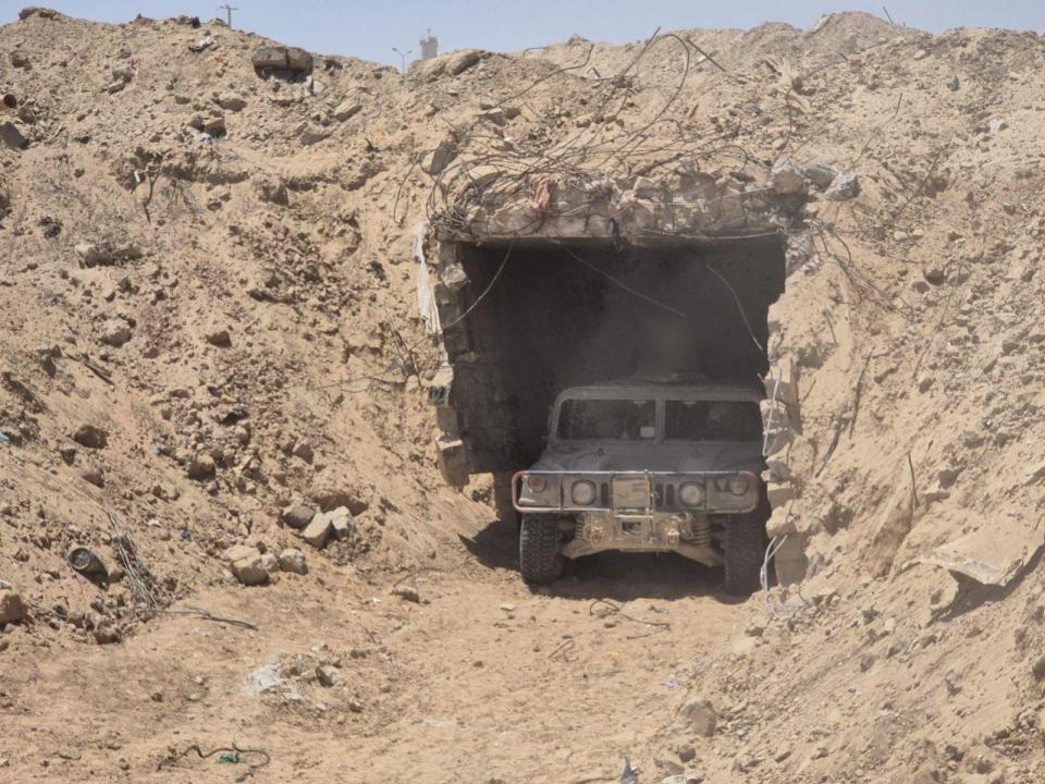 Purported entrance to tunnel with military vehicle